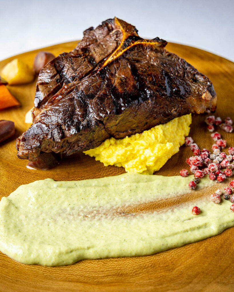 Elk T-Bone with winter root vegetables, polenta and candied peppercorns.